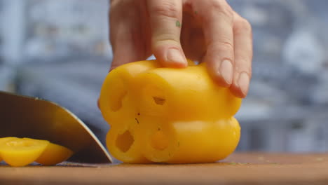 Close-up-of-cut-yellow-peppers-on-a-board-in-the-kitchen-on-a-wooden-board.